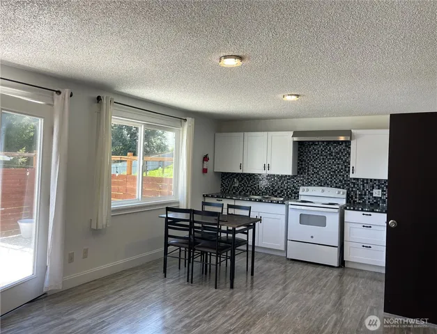 a view of kitchen with furniture and refrigerator