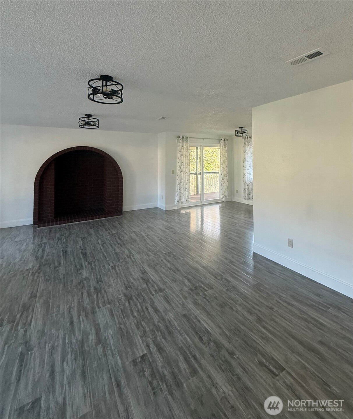 1017 Ballentine Street Raymond, WA 98577 - Photo 7 of 33 a view of empty room with wooden floor