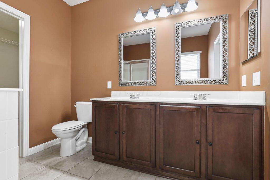 6163 Jennis Road Westerville, OH 43081 - Photo 16 of 44 • Ceramic tile flooring
• Paprika painted walls
• Enclosed vanity with double
bowl, cultured marble sinktop
• Garden tub with ceramic tile
surround
• Shower stall with glass
enclosure & ceramic tile
surround
• Ceiling exhaust
• 5 bulb wall light
• Mirrored medicine cabinet
• 2” blinds