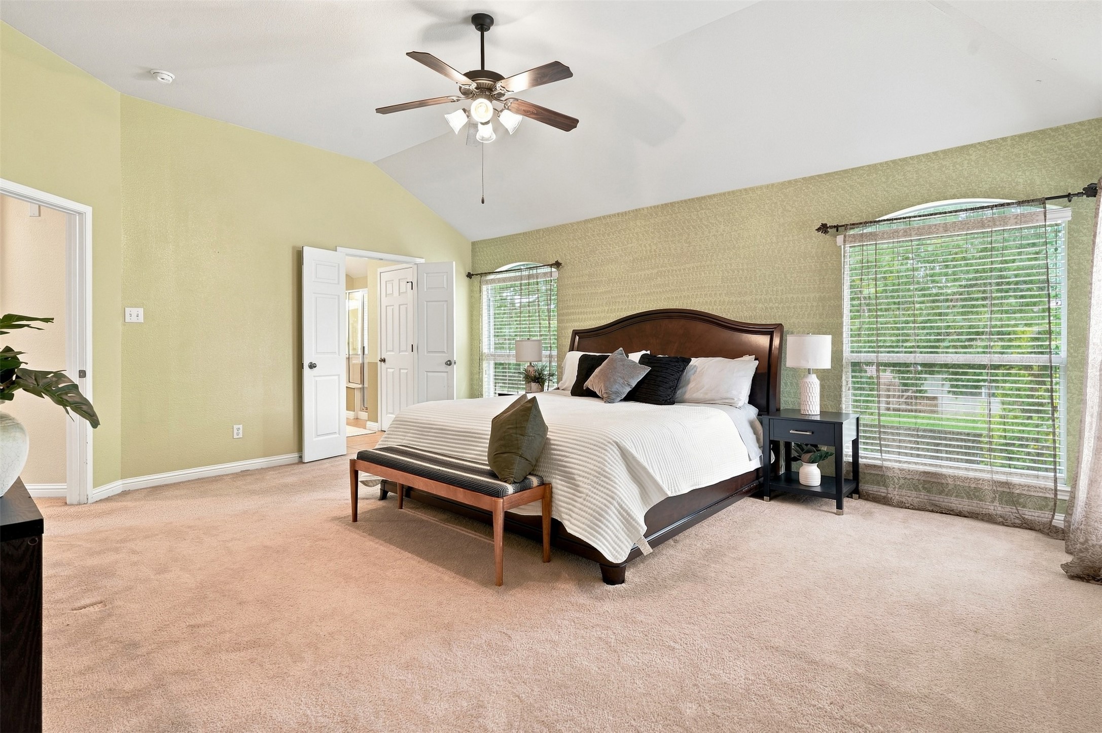 1116 Canyon Maple Road Pflugerville, TX 78660 - Photo 22 of 32 Vaulted ceilings and natural light define this restful main suite with dual arched windows.