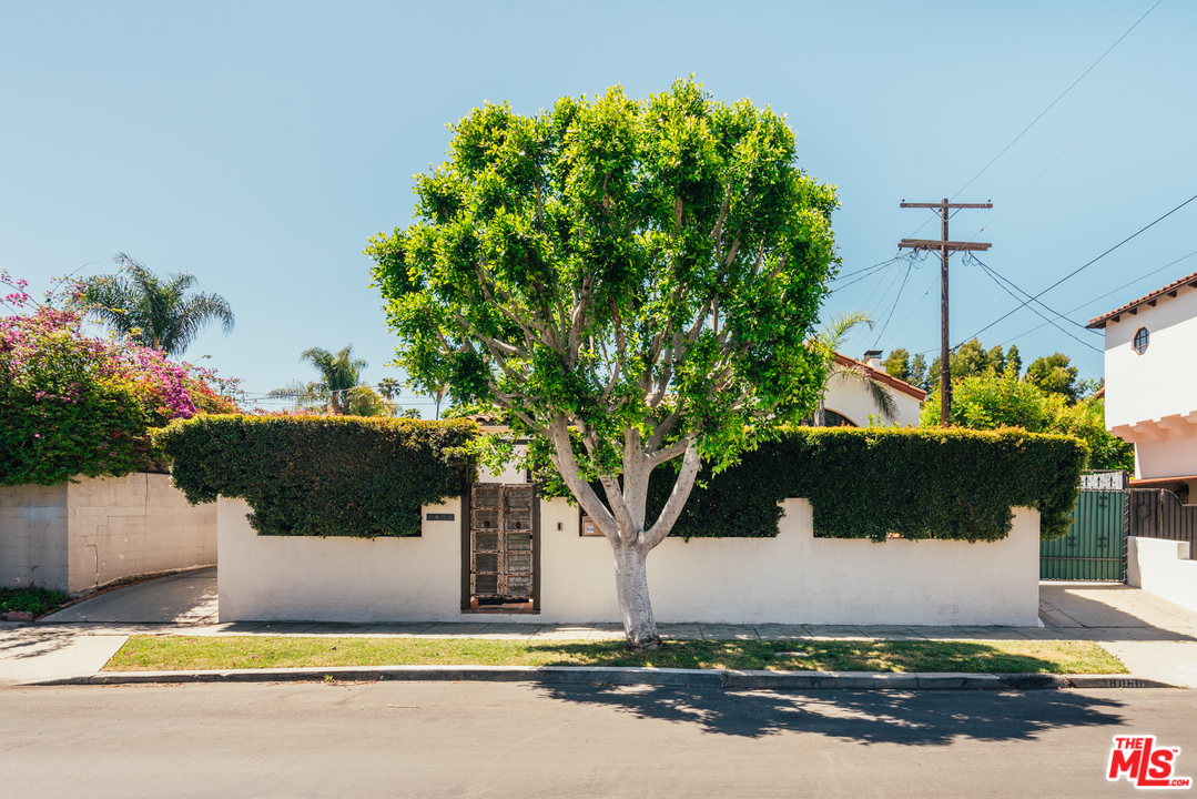 8060 Clinton Street Los Angeles, CA 90048 - Photo 2 of 8 a view of a house with a tree and a yard