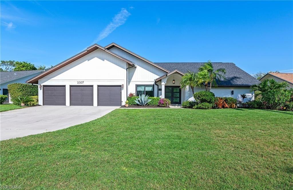 a front view of a house with a yard and garage