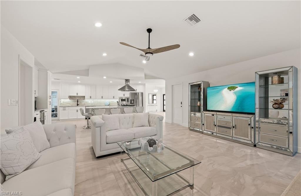 2307 Queens Way Naples, FL 34112 - Photo 16 of 41 a living room with furniture and a flat screen tv