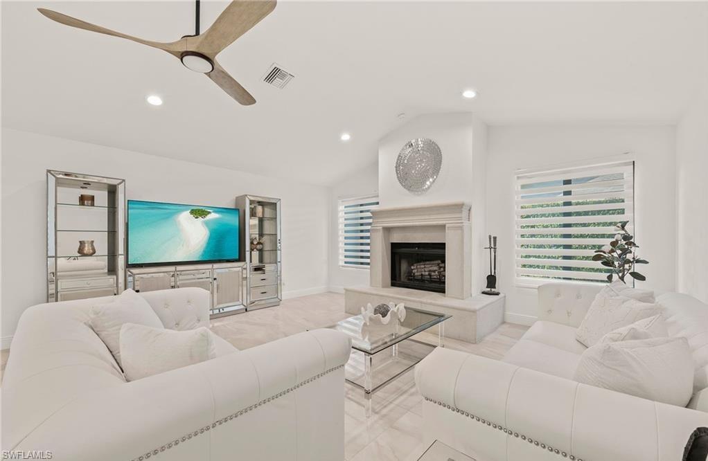 2307 Queens Way Naples, FL 34112 - Photo 17 of 41 a living room with furniture and a flat screen tv
