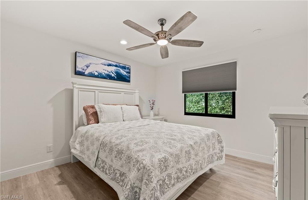 2307 Queens Way Naples, FL 34112 - Photo 24 of 41 a bedroom with bed and window