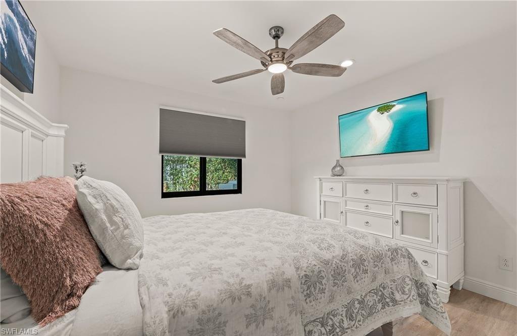 2307 Queens Way Naples, FL 34112 - Photo 25 of 41 a bedroom with a bed and a flat screen tv