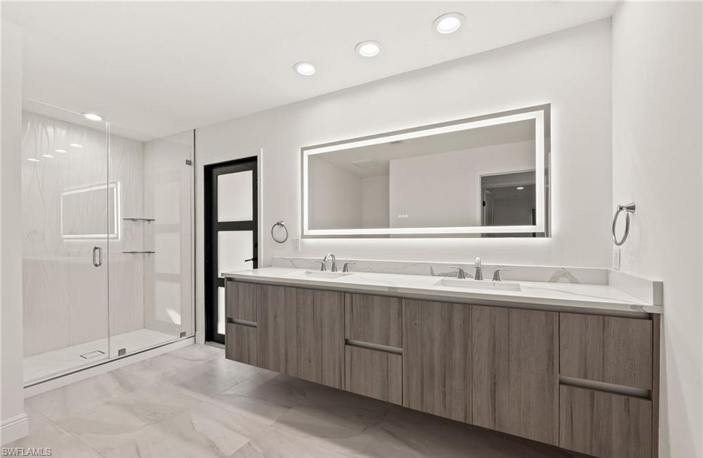 2307 Queens Way Naples, FL 34112 - Photo 26 of 41 a bathroom with a double vanity sink and mirror