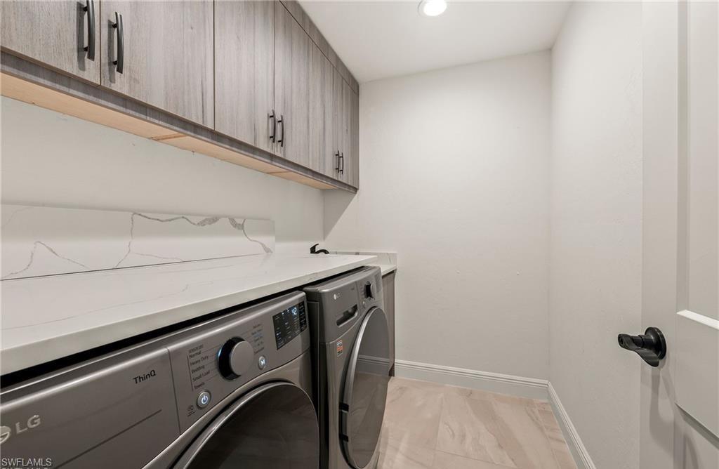 2307 Queens Way Naples, FL 34112 - Photo 27 of 41 a utility room with dryer and washer