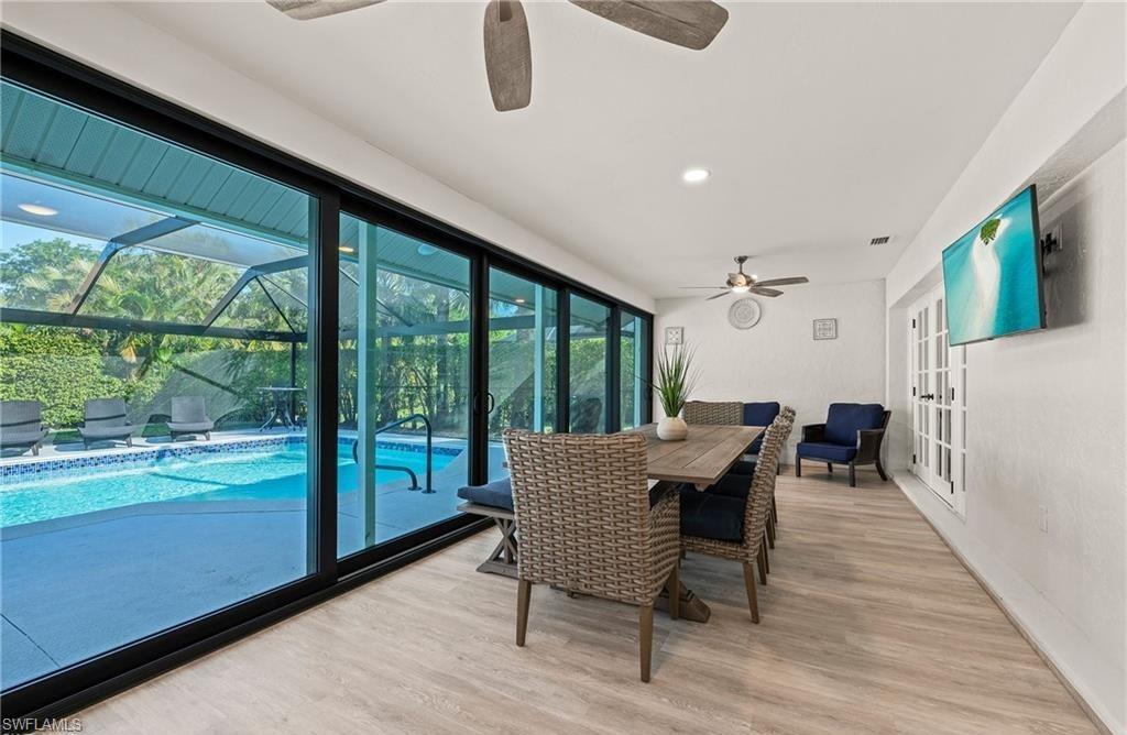 2307 Queens Way Naples, FL 34112 - Photo 29 of 41 a dining room with furniture and wooden floor