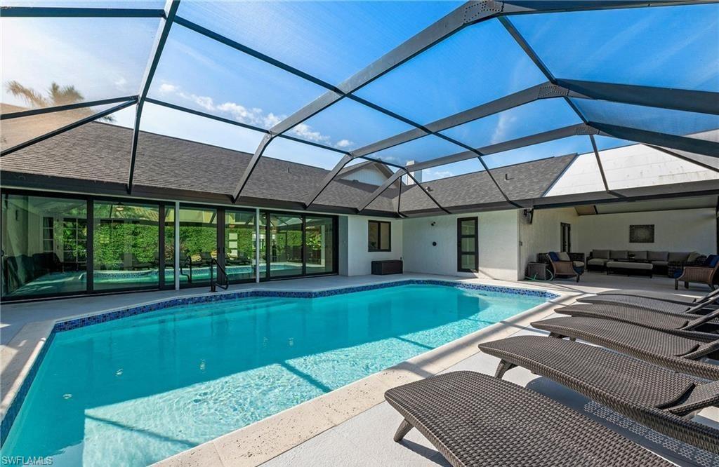 2307 Queens Way Naples, FL 34112 - Photo 32 of 41 a view of a backyard with a sitting area