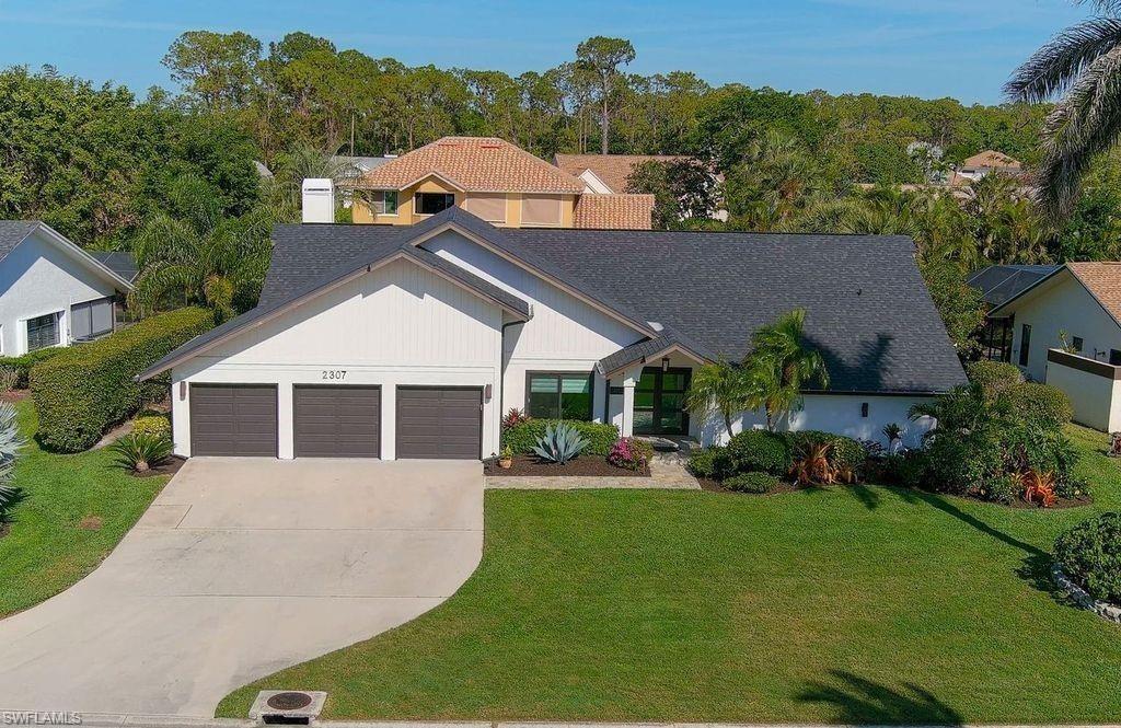 2307 Queens Way Naples, FL 34112 - Photo 36 of 41 front view of house with a yard
