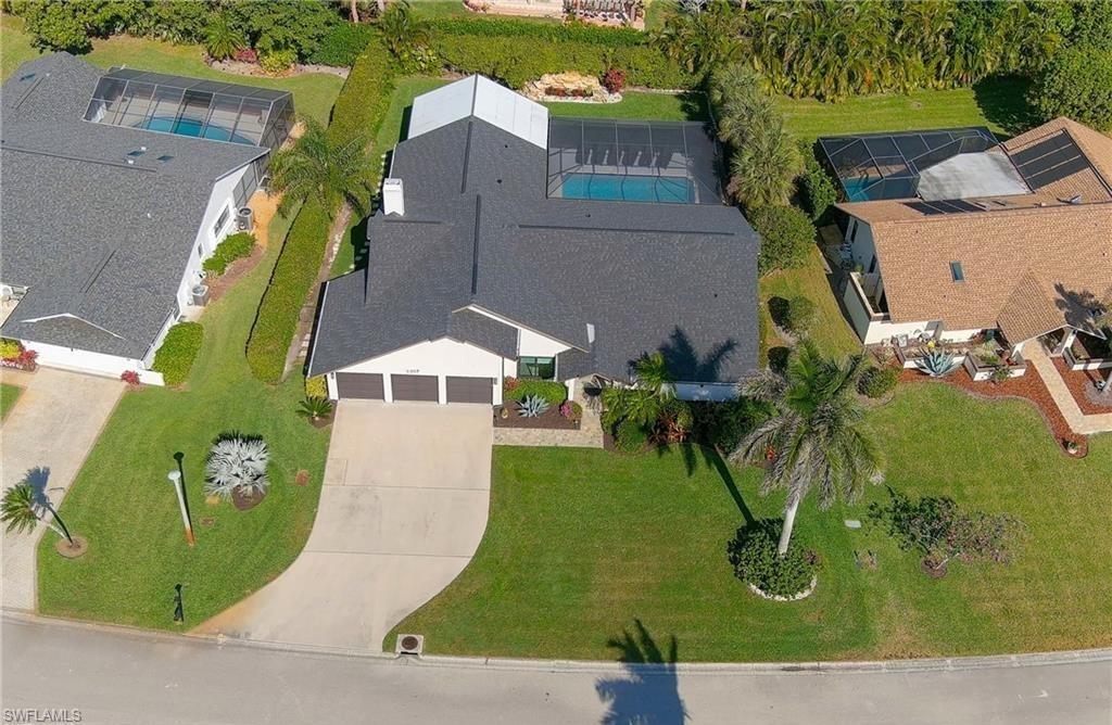 2307 Queens Way Naples, FL 34112 - Photo 37 of 41 an aerial view of a house with a swimming pool