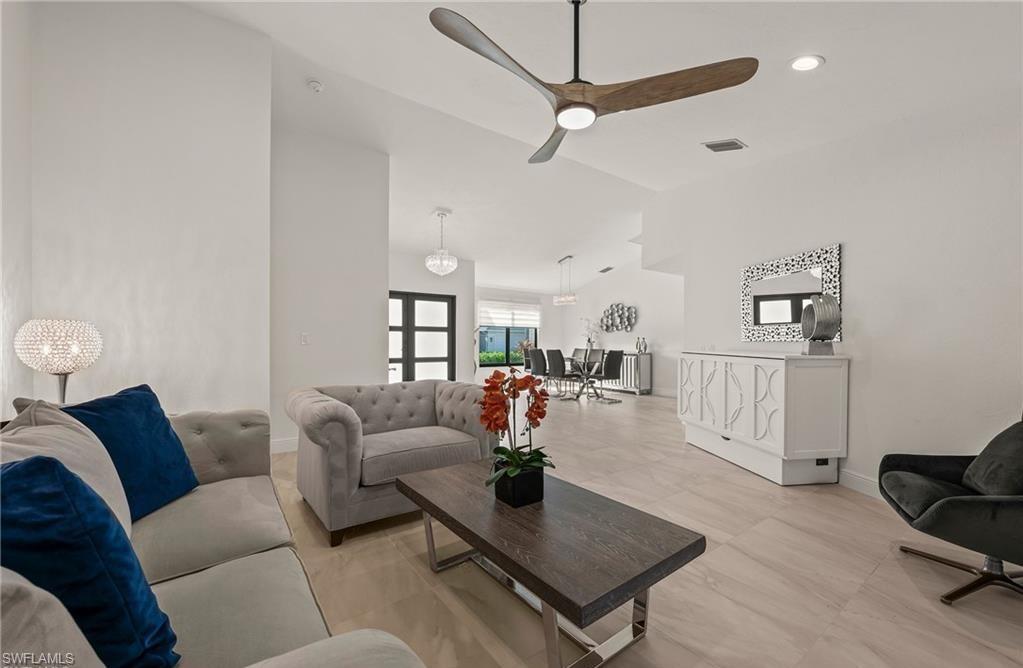2307 Queens Way Naples, FL 34112 - Photo 4 of 41 a living room with furniture and a wooden floor