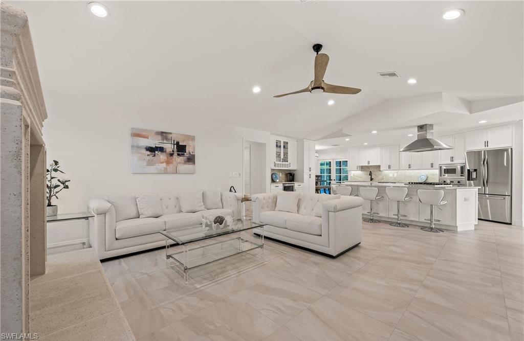 2307 Queens Way Naples, FL 34112 - Photo 7 of 41 a living room with furniture white walls and white walls