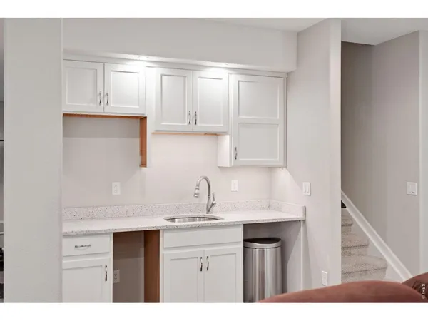 a kitchen with a sink cabinets and a window