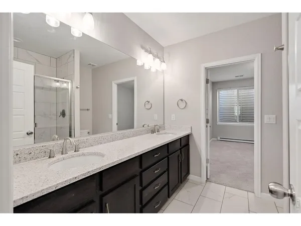a bathroom with a double vanity sink mirror and next