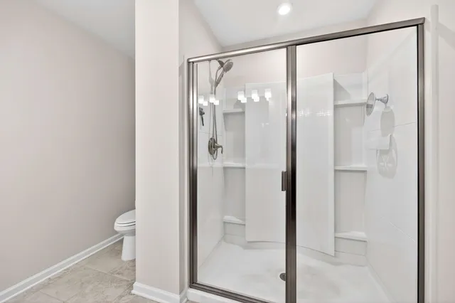 a bathroom with a glass shower door