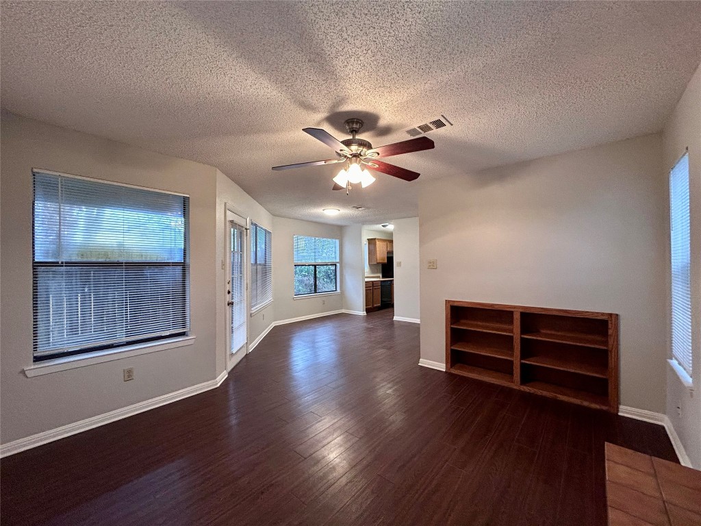 8902 Schick Road, Unit D Austin, TX 78729 - Photo 1 of 1 a view of an empty room with a window and wooden floor