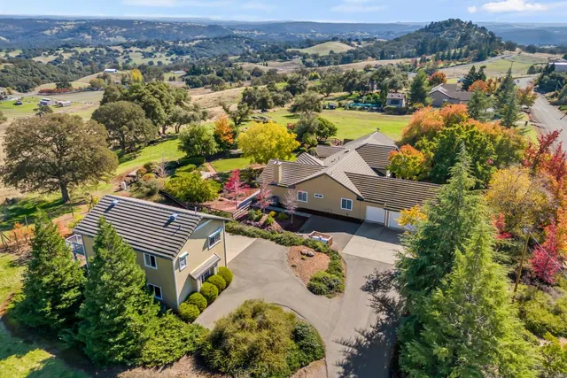 an aerial view of a house with a lake view