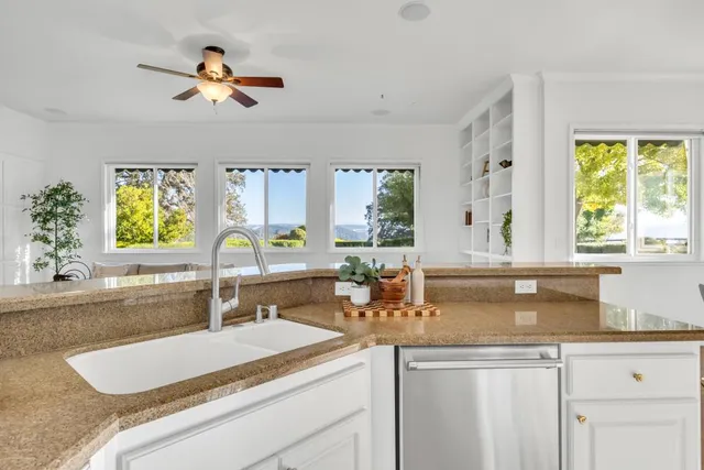 a very nice looking living room with kitchen and a couch