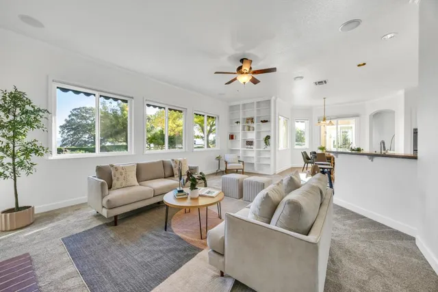 a spacious bedroom with a bed and a ceiling fan