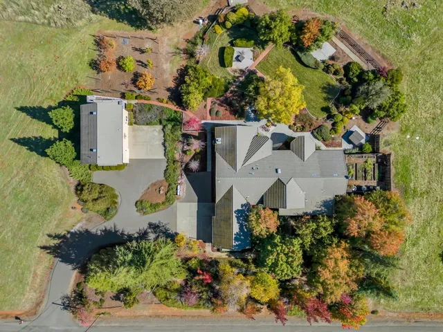 an aerial view of a house with a yard and garden