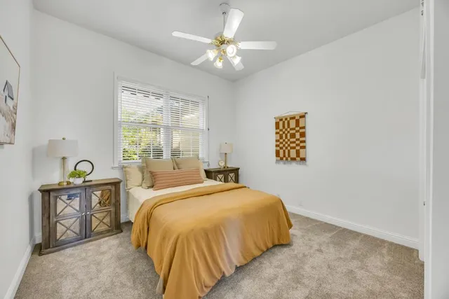 an empty room with closet and a ceiling fan