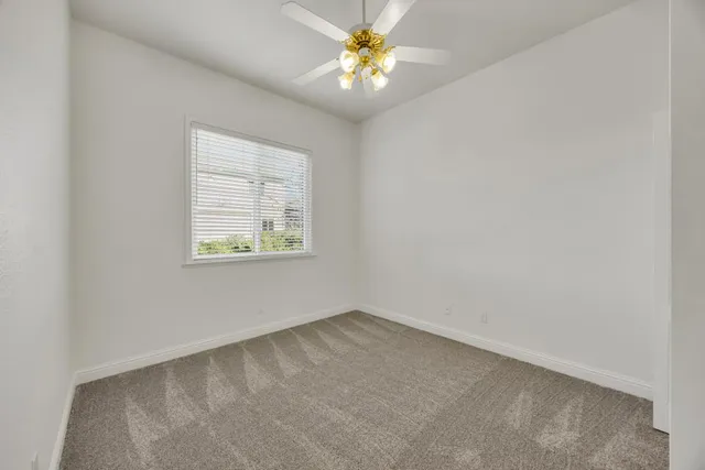 a view of a patio with table and chairs potted plants and wooden fence