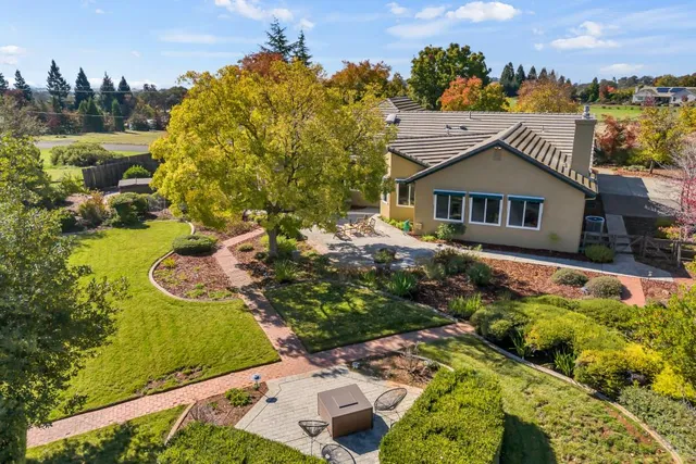a kitchen with stainless steel appliances granite countertop a sink a stove and cabinets