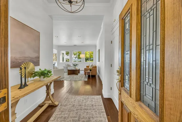 a view of a dining room with furniture and a potted plant