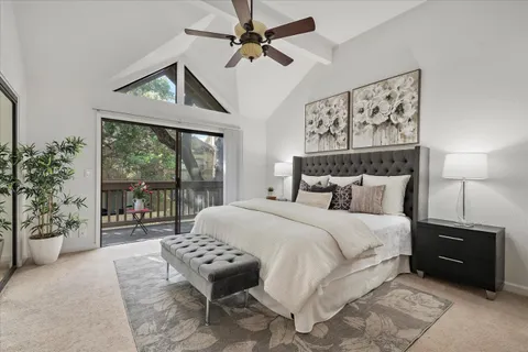 a bedroom with a large bed and a large window