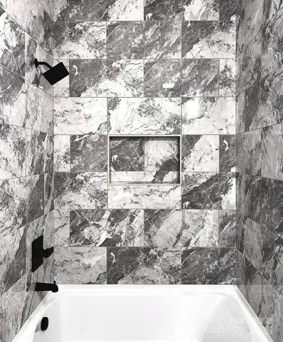 a bathroom with a bathtub and a sink