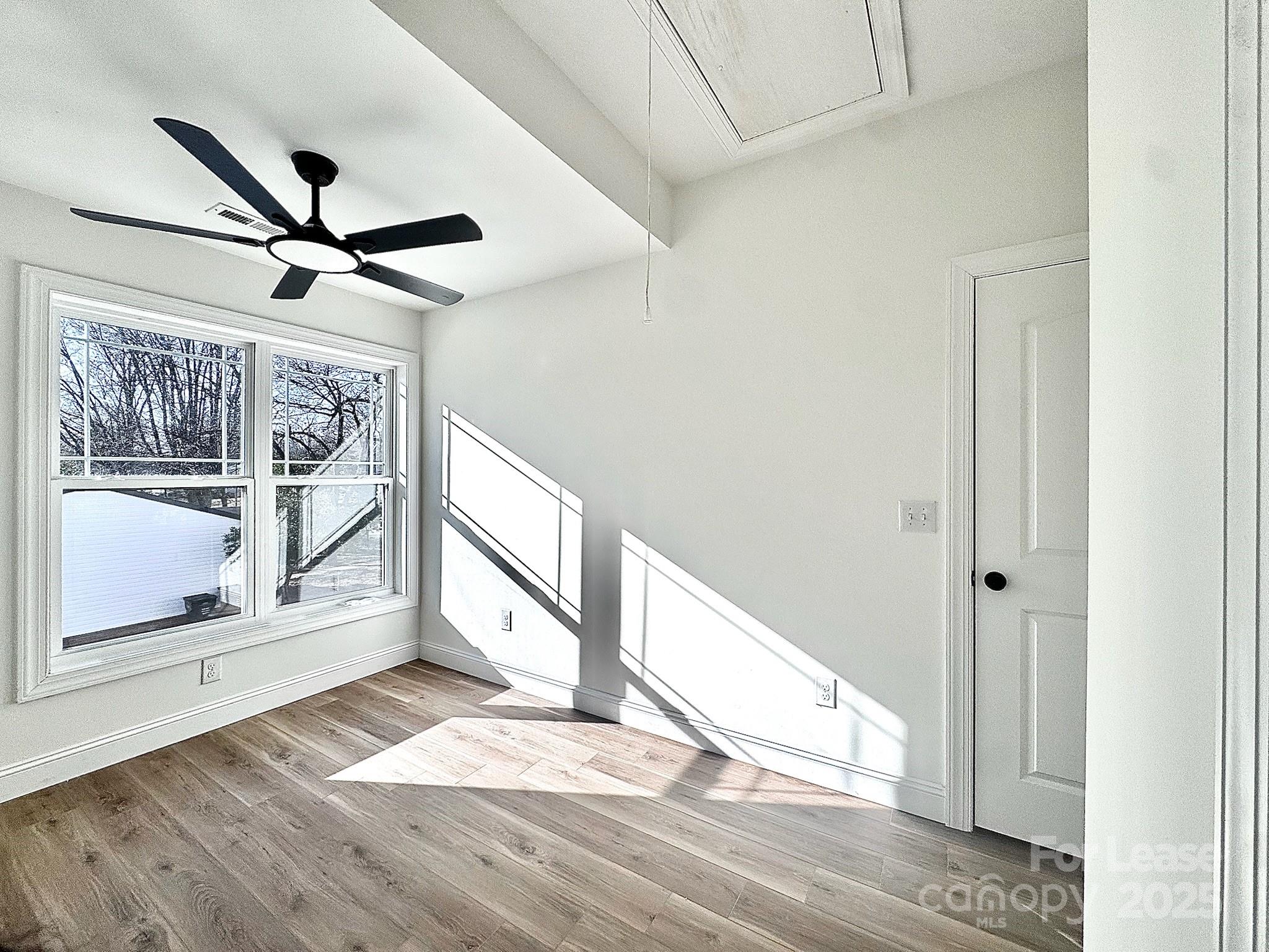 407 Church Street North Concord, NC 28025 - Photo 17 of 20 a view of an empty room with wooden floor and a window