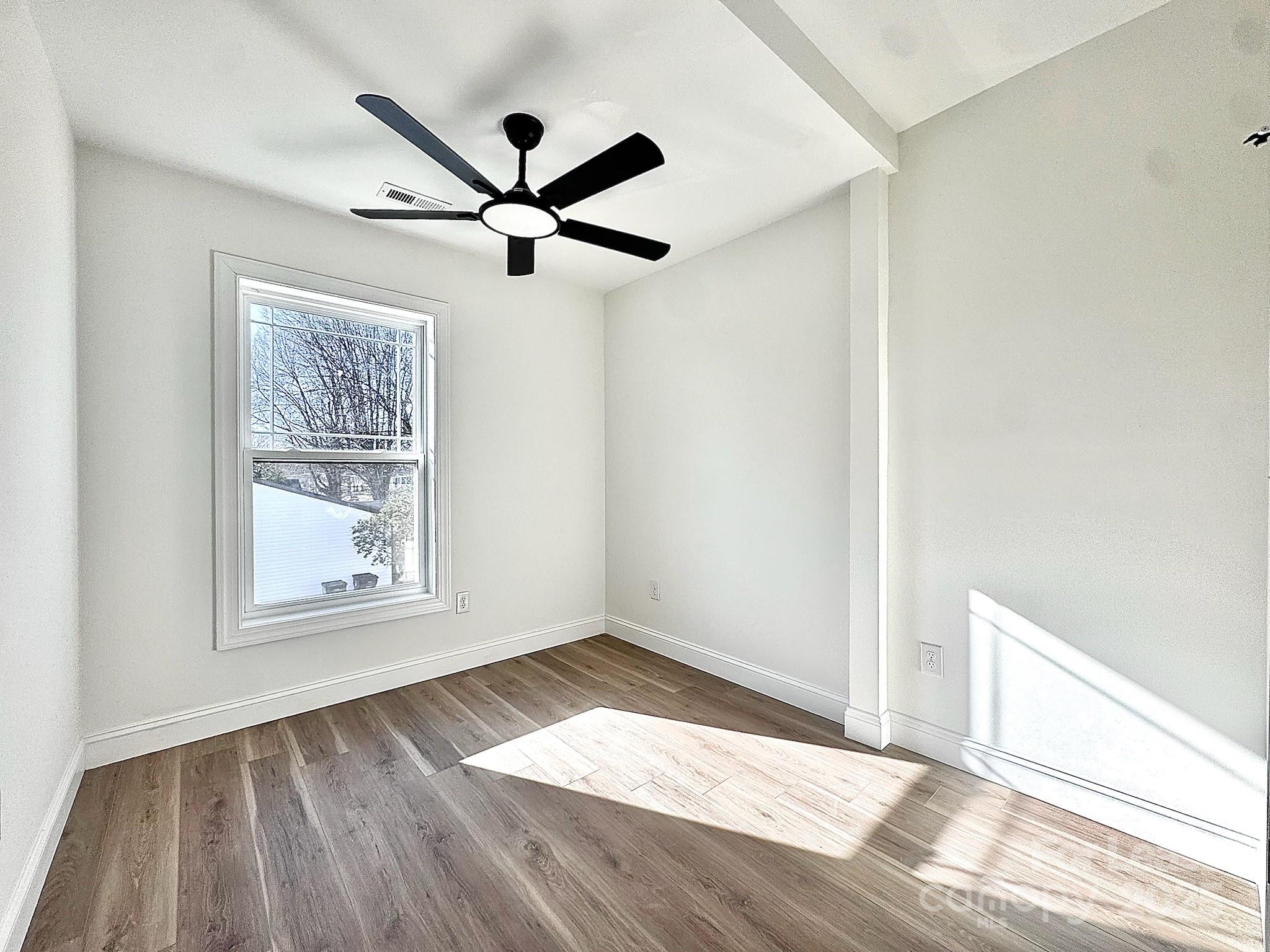 407 Church Street North Concord, NC 28025 - Photo 18 of 20 a view of empty room with wooden floor and fan