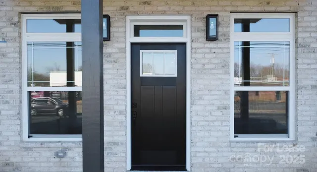 a kitchen with stainless steel appliances a sink a stove a microwave a center island and cabinets