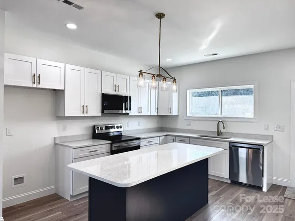 a kitchen with a sink cabinets and window