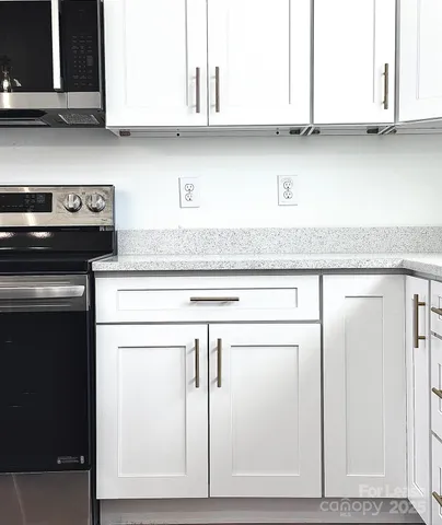 a kitchen with stainless steel appliances a cabinets and a counter top space