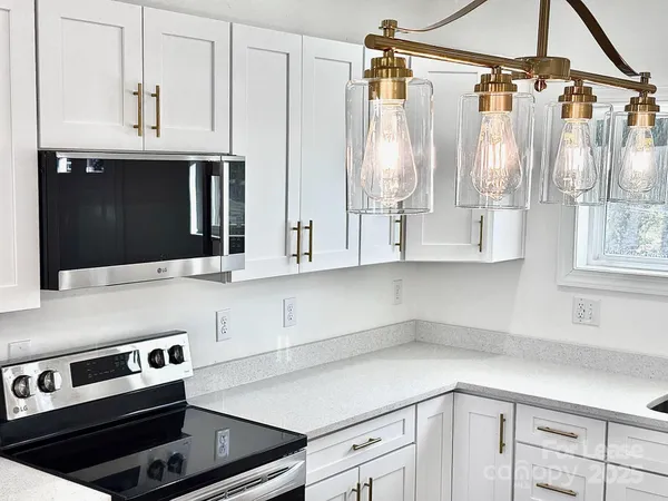 a kitchen with a sink cabinets and window