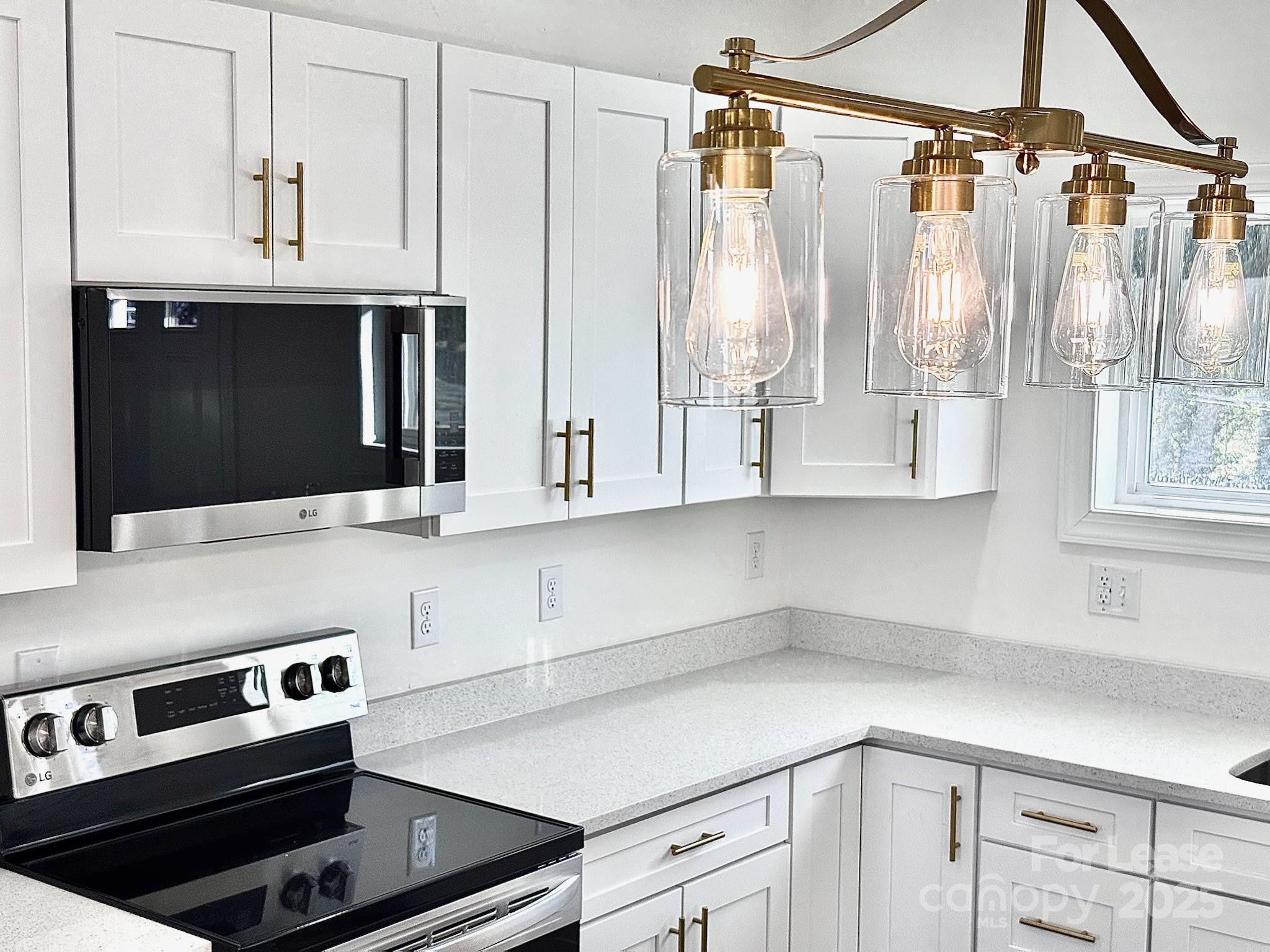 407 Church Street North Concord, NC 28025 - Photo 7 of 20 a kitchen with stainless steel appliances a cabinets and a counter top space