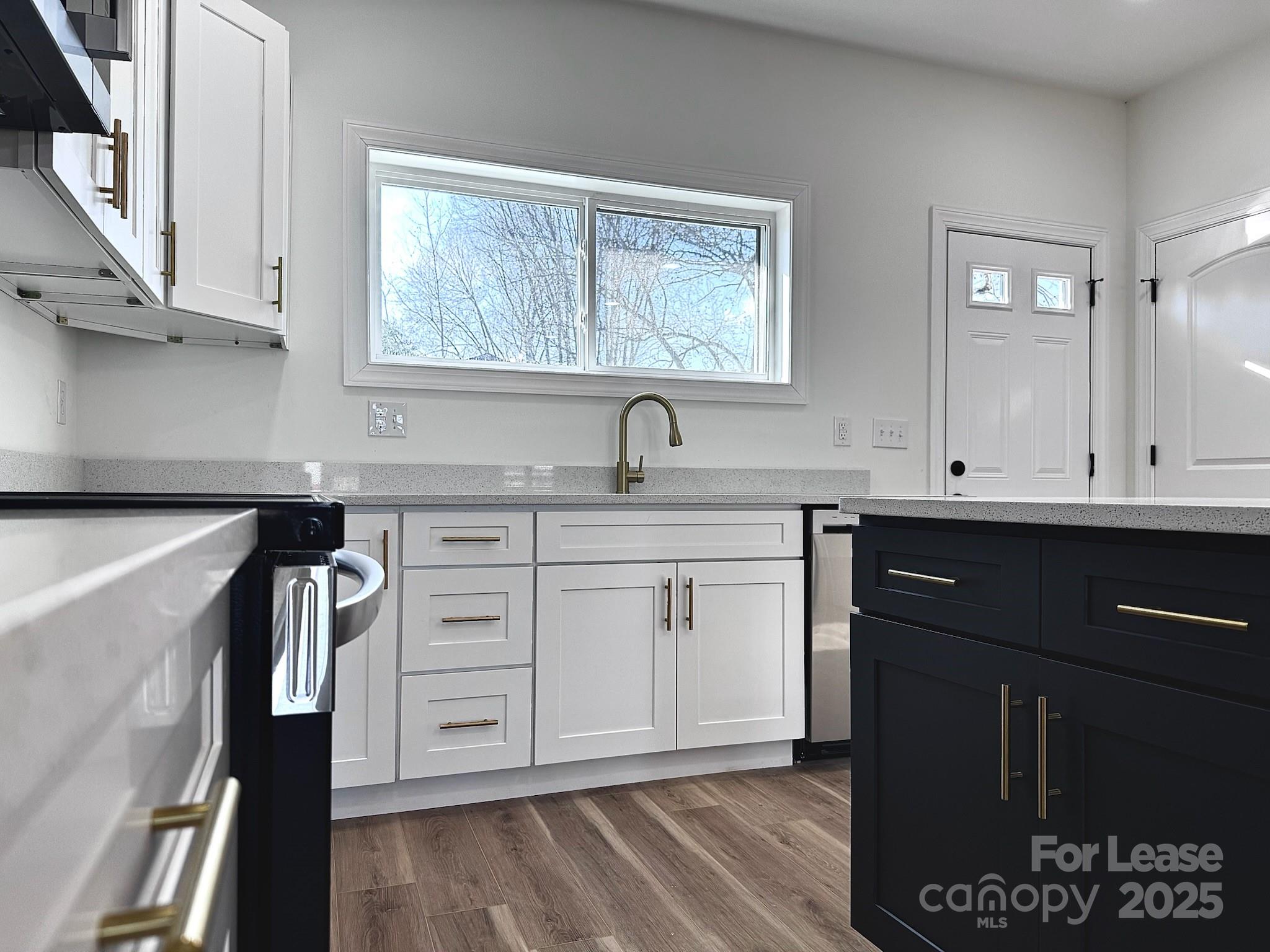 407 Church Street North Concord, NC 28025 - Photo 8 of 20 a kitchen with a sink cabinets and window