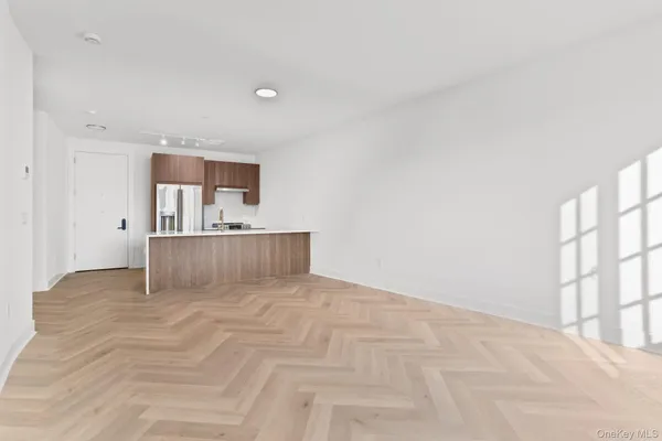 an empty room with windows and closet