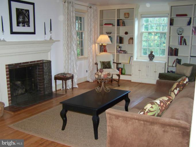 107 Bellemore Road Baltimore, MD 21210 - Photo 3 of 16 a living room with furniture a table and a fireplace