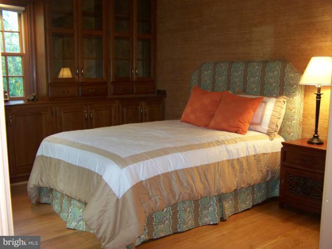 107 Bellemore Road Baltimore, MD 21210 - Photo 4 of 16 a bedroom with a bed and a night stand