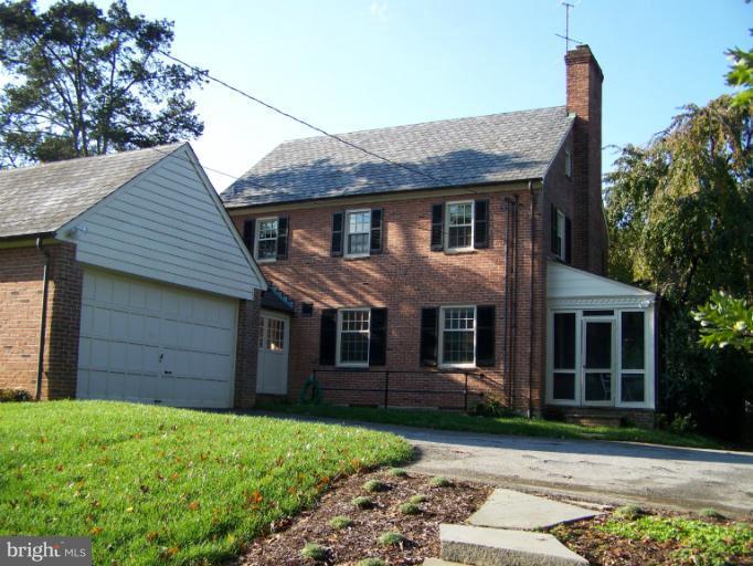 107 Bellemore Road Baltimore, MD 21210 - Photo 5 of 16 a front view of a house with a garden