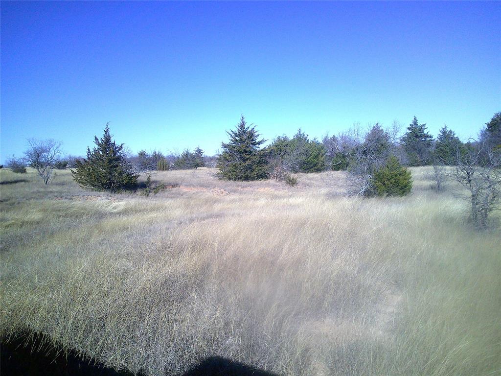 a view of a dirt road and a building