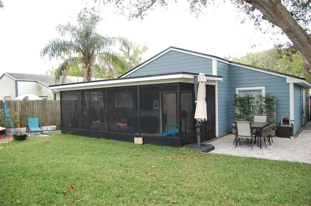 a view of a house with a yard and sitting area
