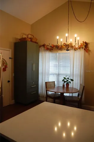 a living room with furniture a lamp and a table