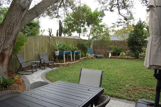 a view of a table and chairs in the garden