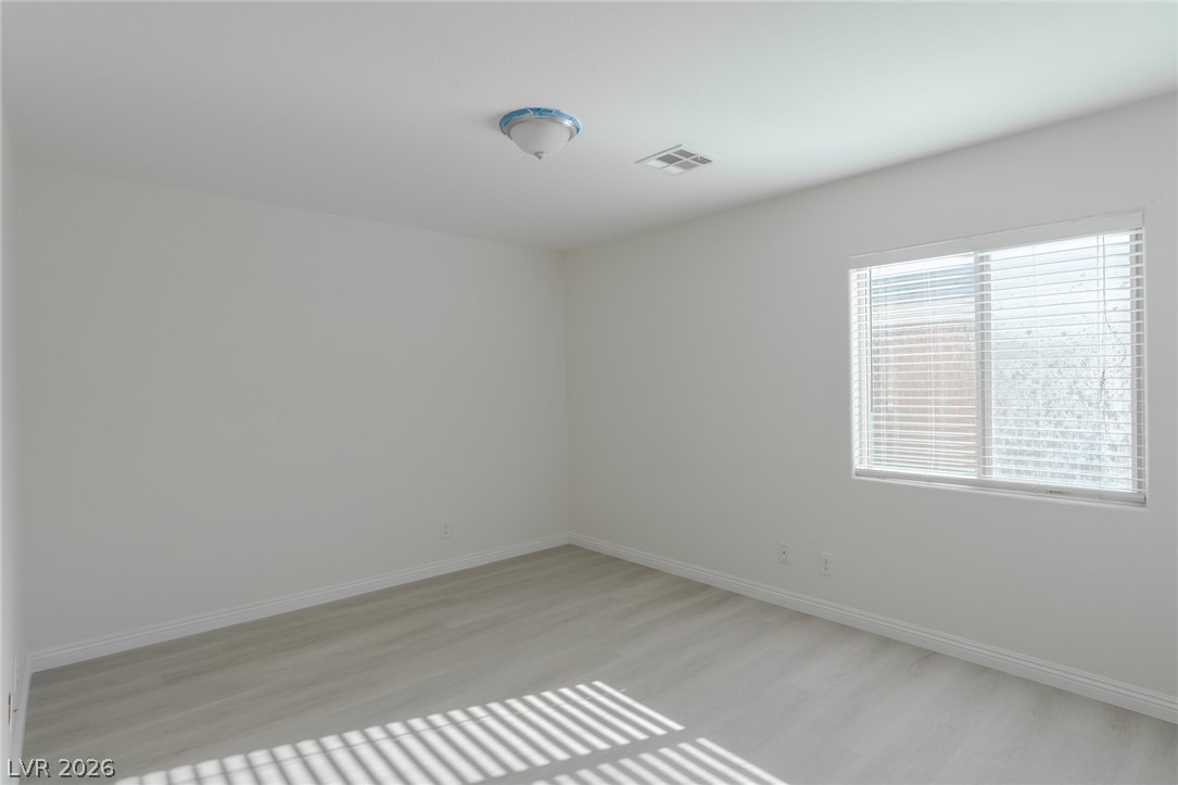 8079 Buffalo Ranch Avenue Las Vegas, NV 89147 - Photo 15 of 29 Clean lines and smooth flooring define this versatile secondary bedroom space.