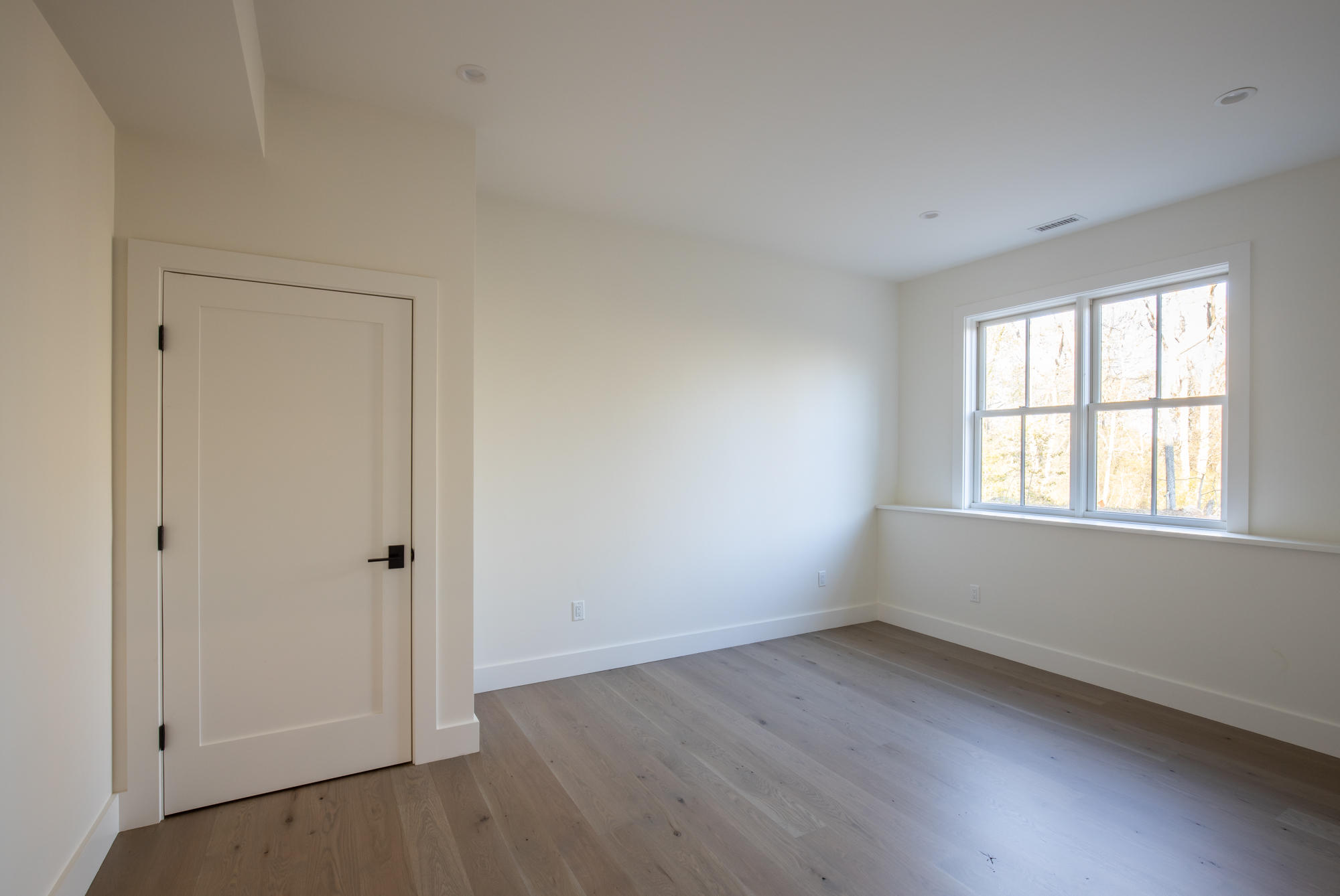 25 Luce Farm Road West Tisbury, MA 02568 - Photo 18 of 26 an empty room with wooden floor and windows